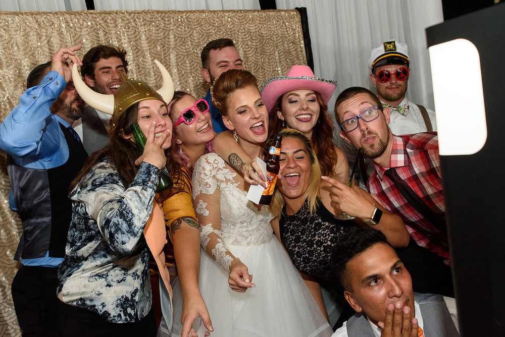 bride with friends in photo booth by Meisner Productions