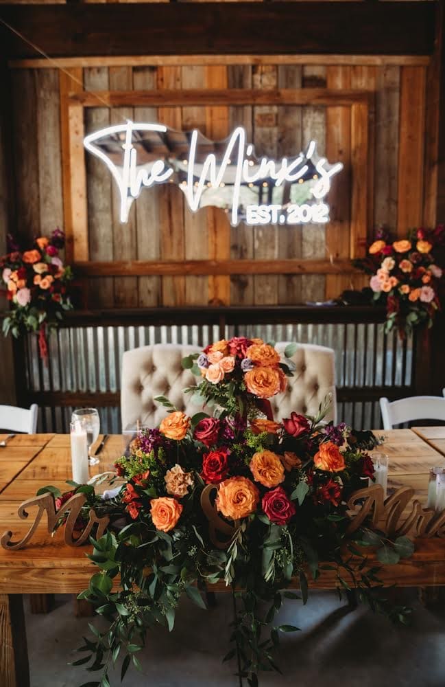 centerpiece of ombre salmon to rust flowers by Petals and Stems Market