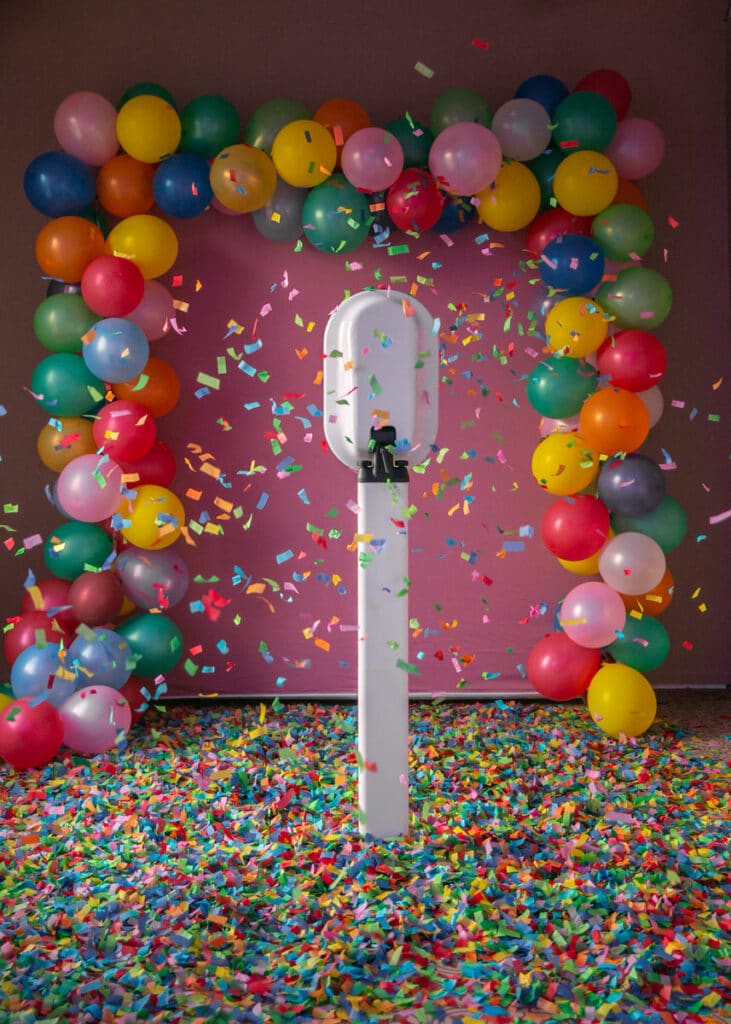 confetti and colorful balloon arch photo op by MyBooth Service