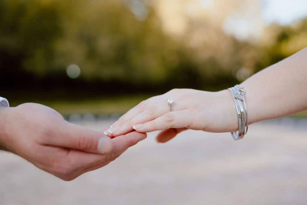 couple showing of engagement ring at Leu Gardens