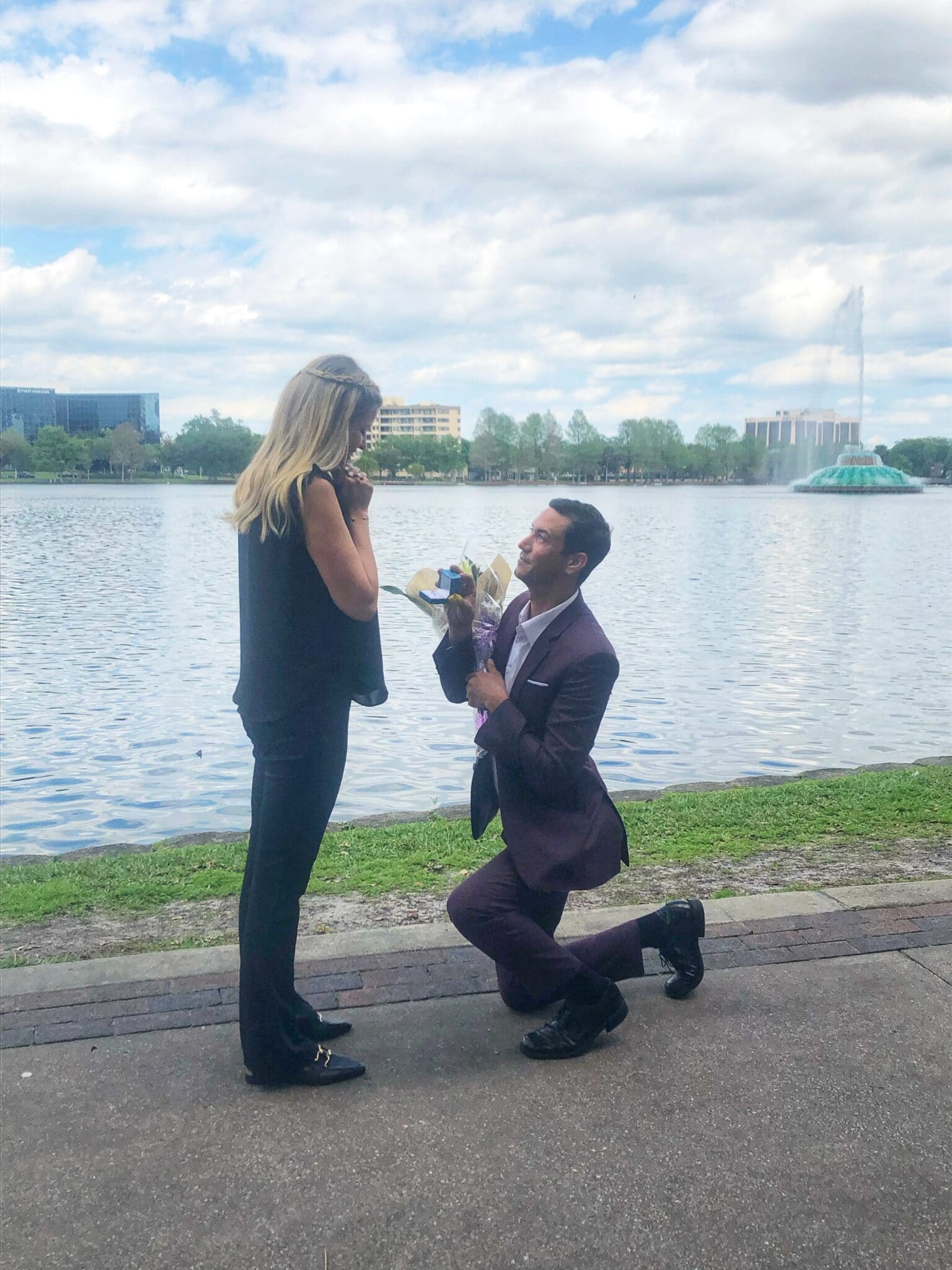 Man kneeling and proposing at Lake Eola, in Orlando, FL