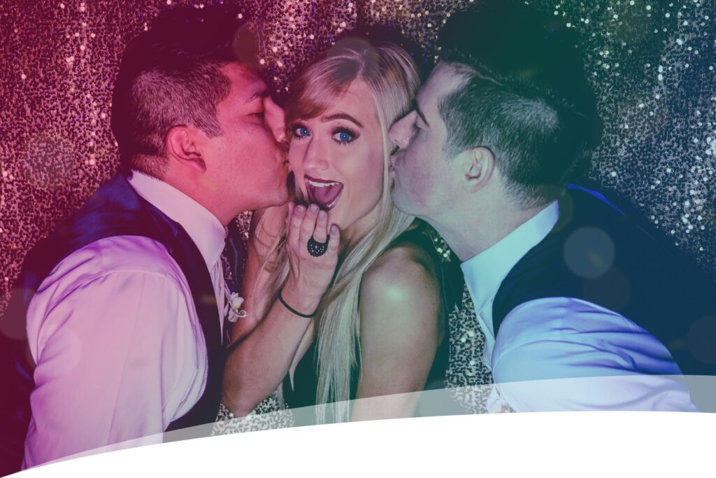 two men kissing a woman in a photo booth from SugarPop Productions
