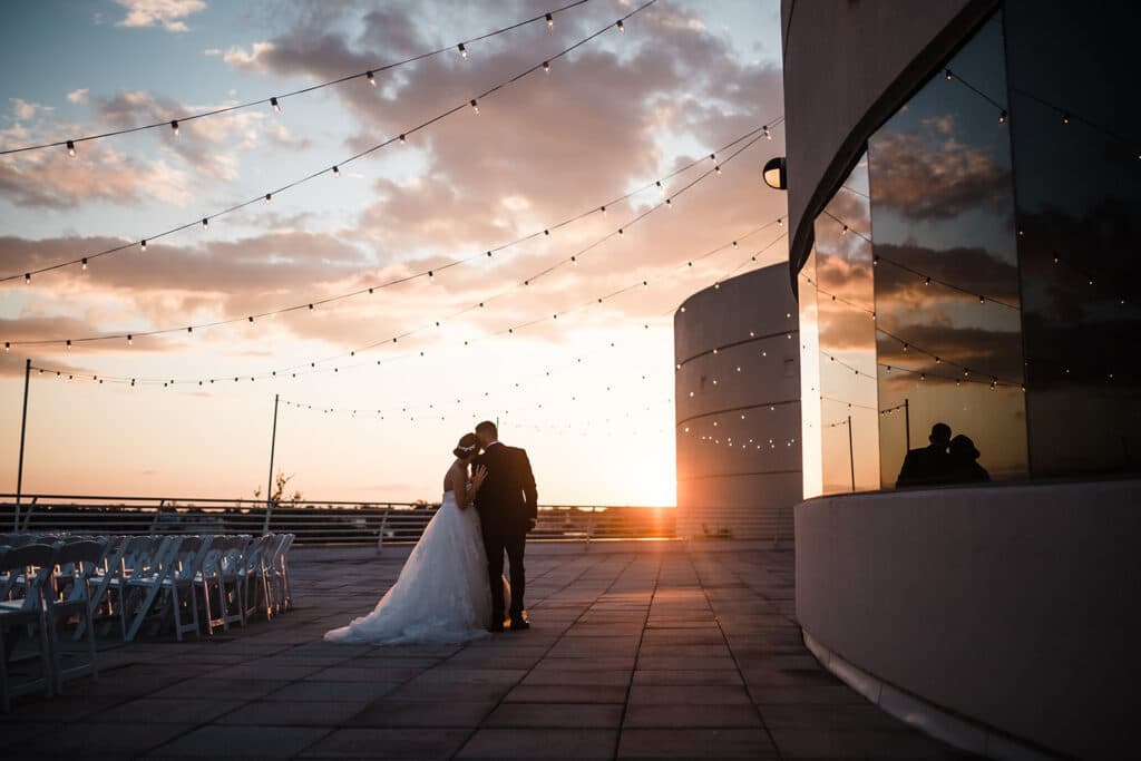 Bride and groom outside of the Orlando Science Center at sunset