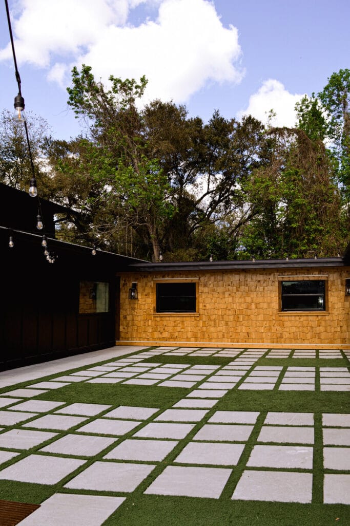 concrete pavers with grass lining courtyard at The Black Barn