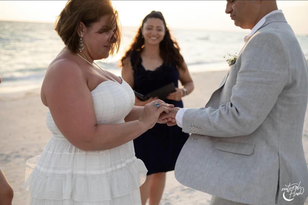 Bride and groom exchanging vows on a beach