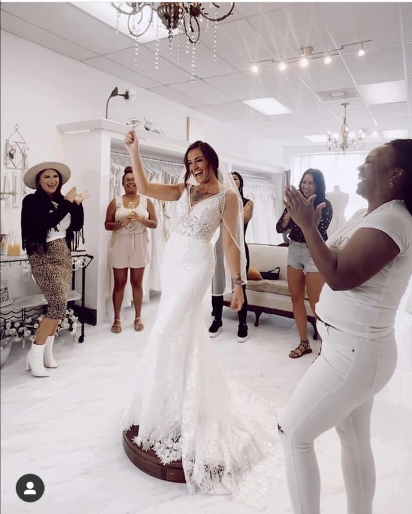 woman shopping with her family and friends finding the right wedding gown from the Ivy Bridal Shop