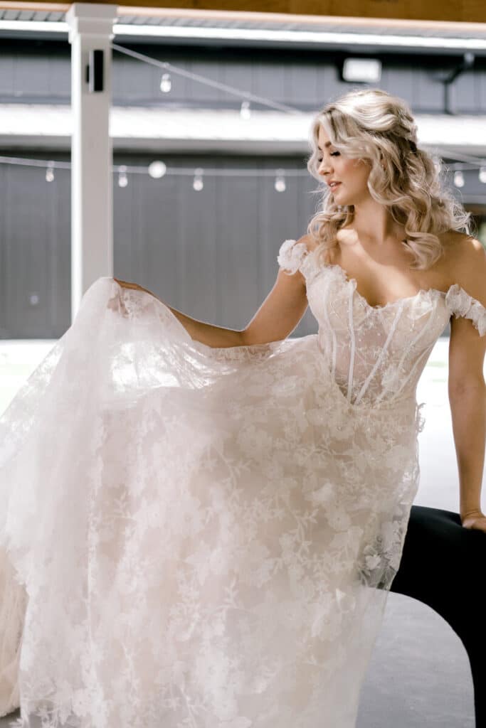 bride posing in corseted wedding gown at The Black Barn