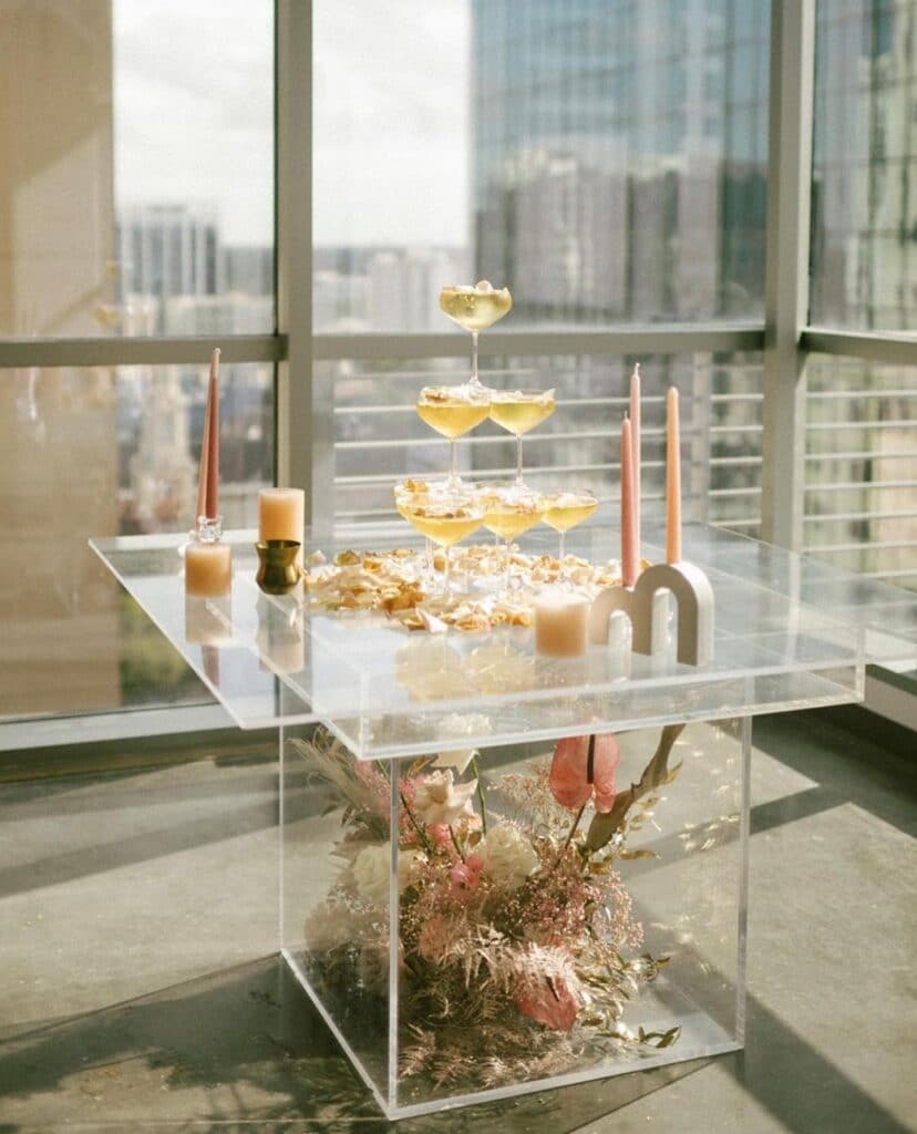 champagne tower against a glass wall in a high rise poured by My Bar Service