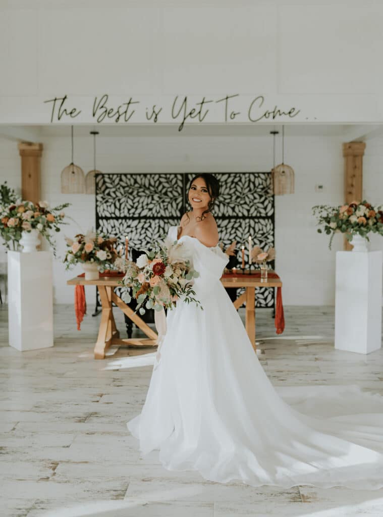 bride standing in white room at The Black Barn