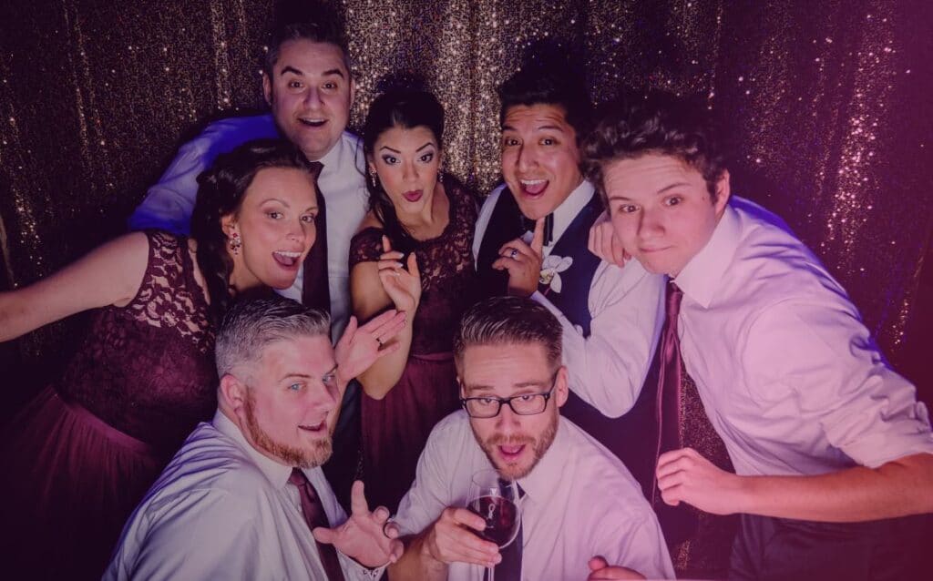 group of people smiling in a photo booth from SugarPop Productions