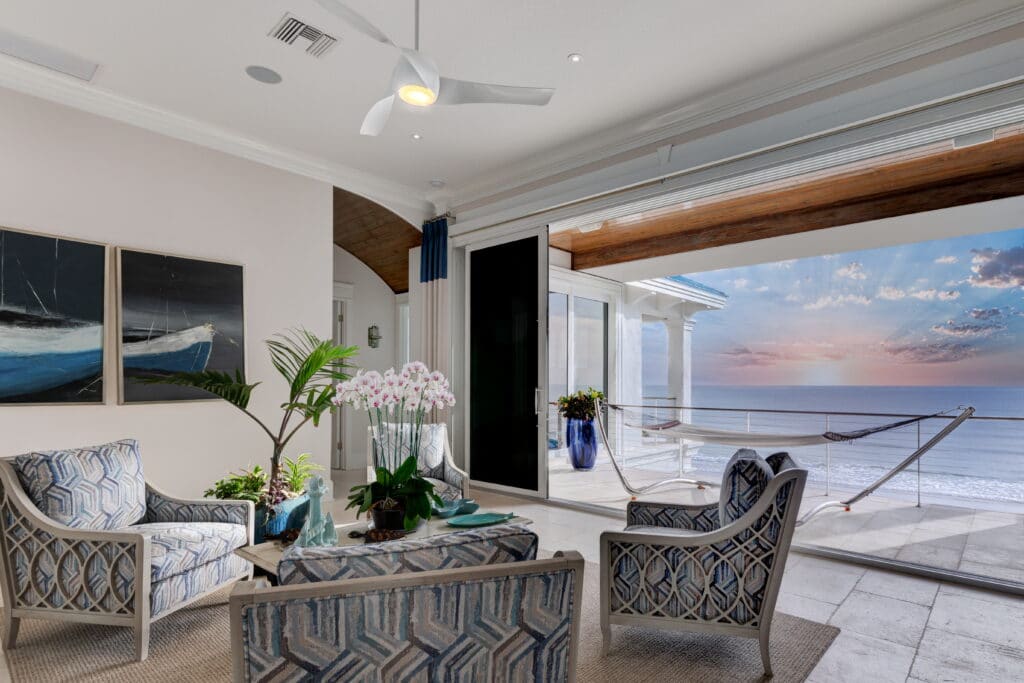 living room looking over ocean sunset at Joy by the Sea