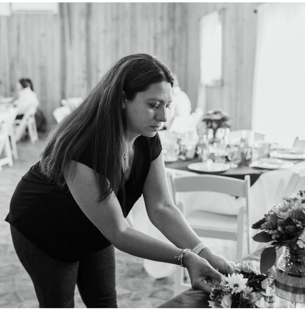 Woman arranging flowers in preparation for a reception