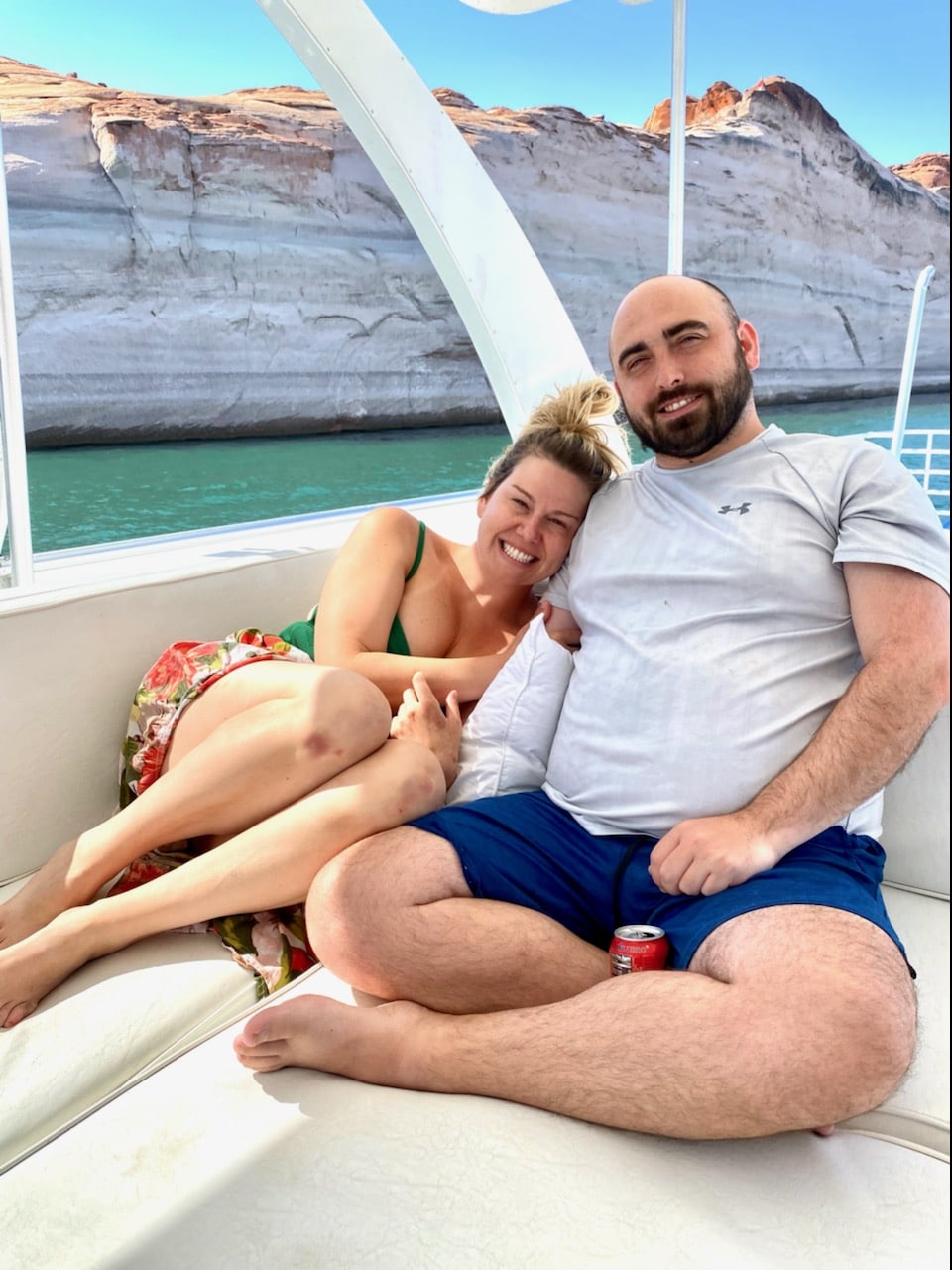 couple lounging on a boat in a lake