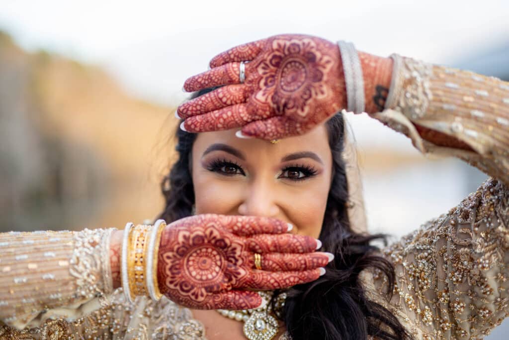 photo of a bride showing her hennaed hands by Sydney Morman Photography
