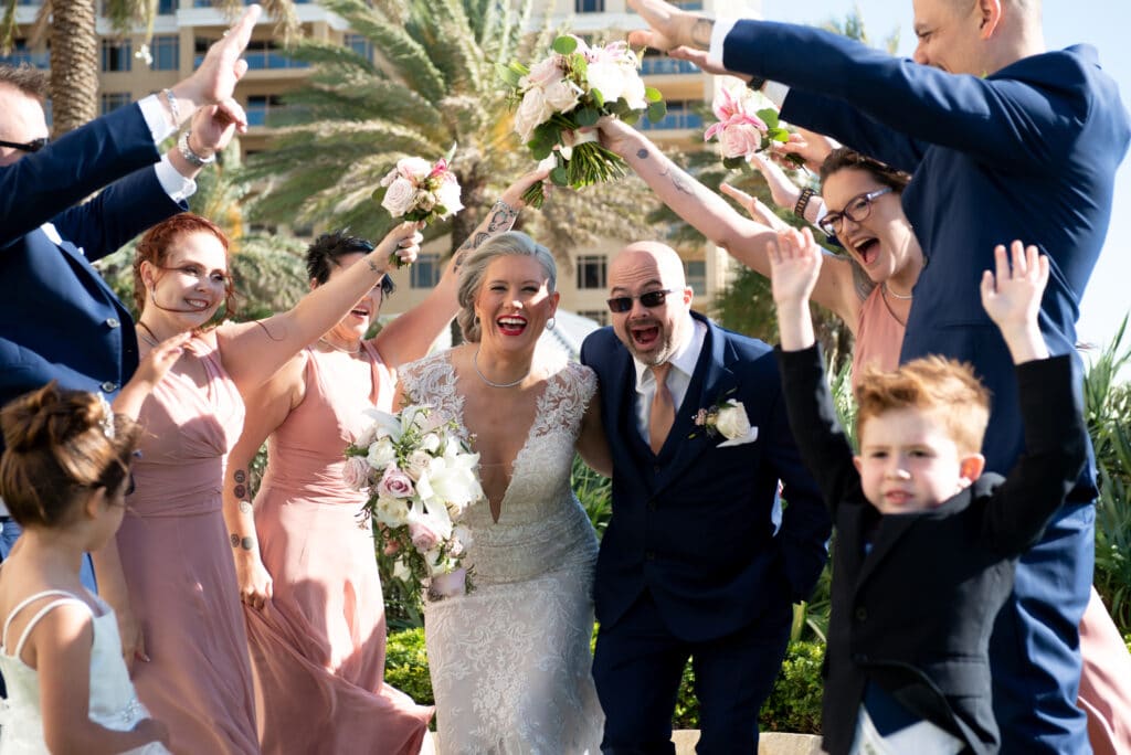 bride and groom exit under human arch of arms coordinated by Classically Cool Event Productions