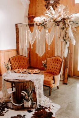 orange, white and natural fibers of macrame seating area by Making It Matthews