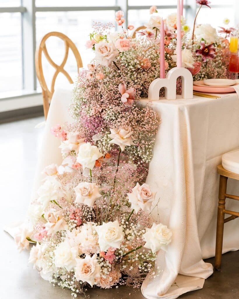 pink roses and babies breath draped off table from In Bloom Florist