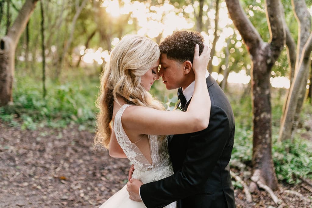 bride and groom having a special moment in the forest at event planned by Just Save the Date
