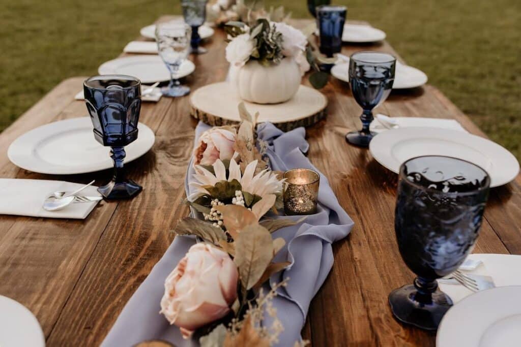 farmhouse table with blue glass wear and accented table runner