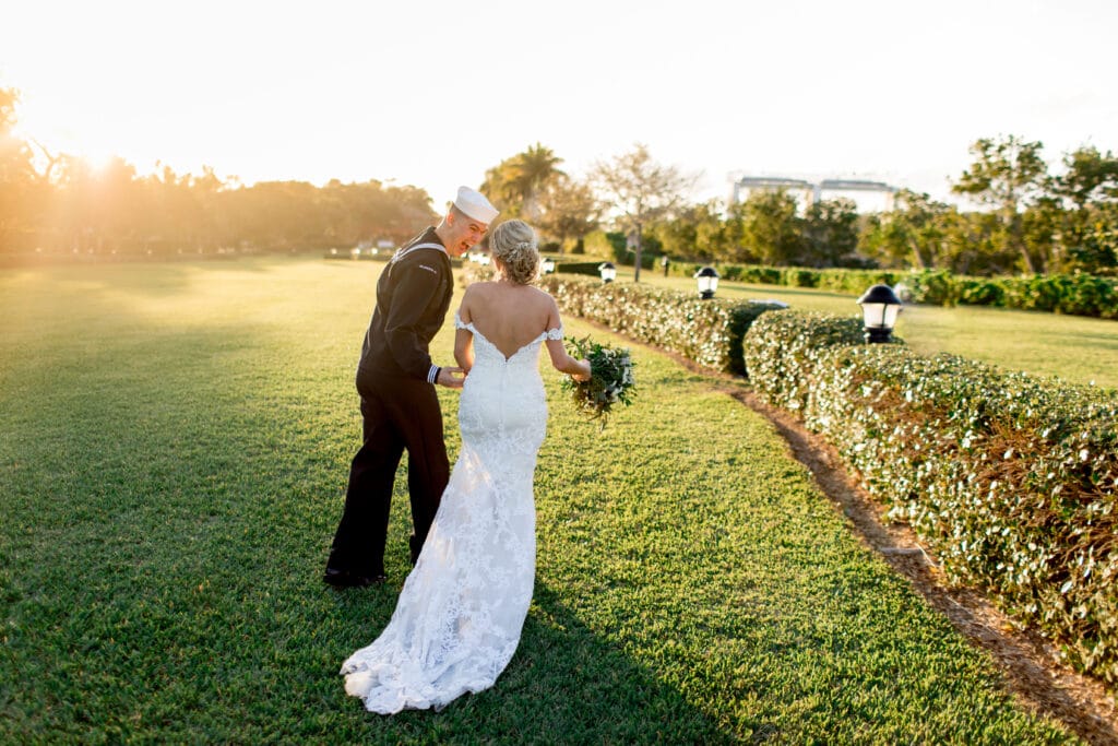 sailor and his bride walking in a garden by Sydney Morman Photography
