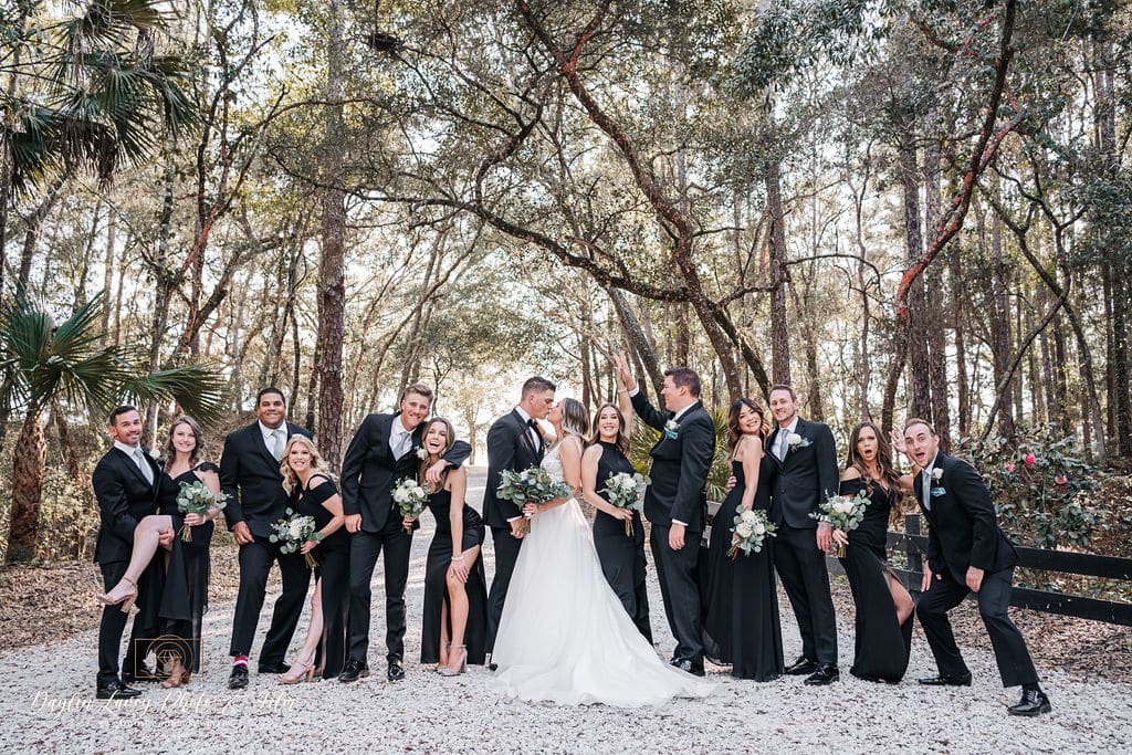 bridal party against a canopy of trees coordinated by SMS Events & Design