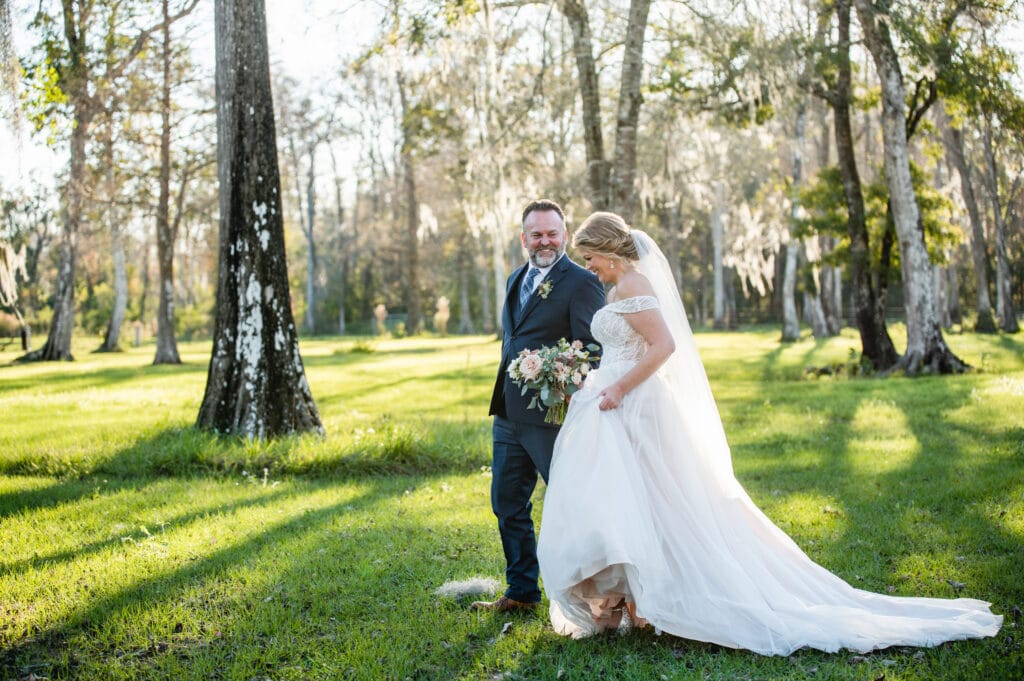 bride and groom walking through the woods coordinated by SMS Events & Design