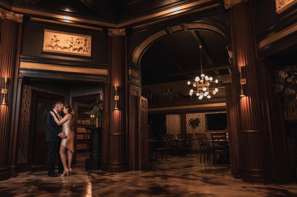 bride and groom having a quiet moment in a special venue with marble floors and chandeliers, photo from Weddings By Ray