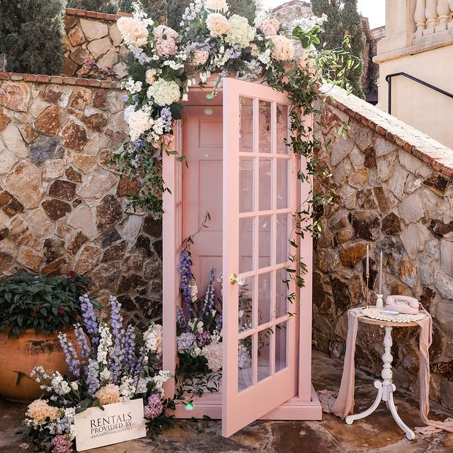 pink telephone booth with pink and white flowers from In Bloom Florist