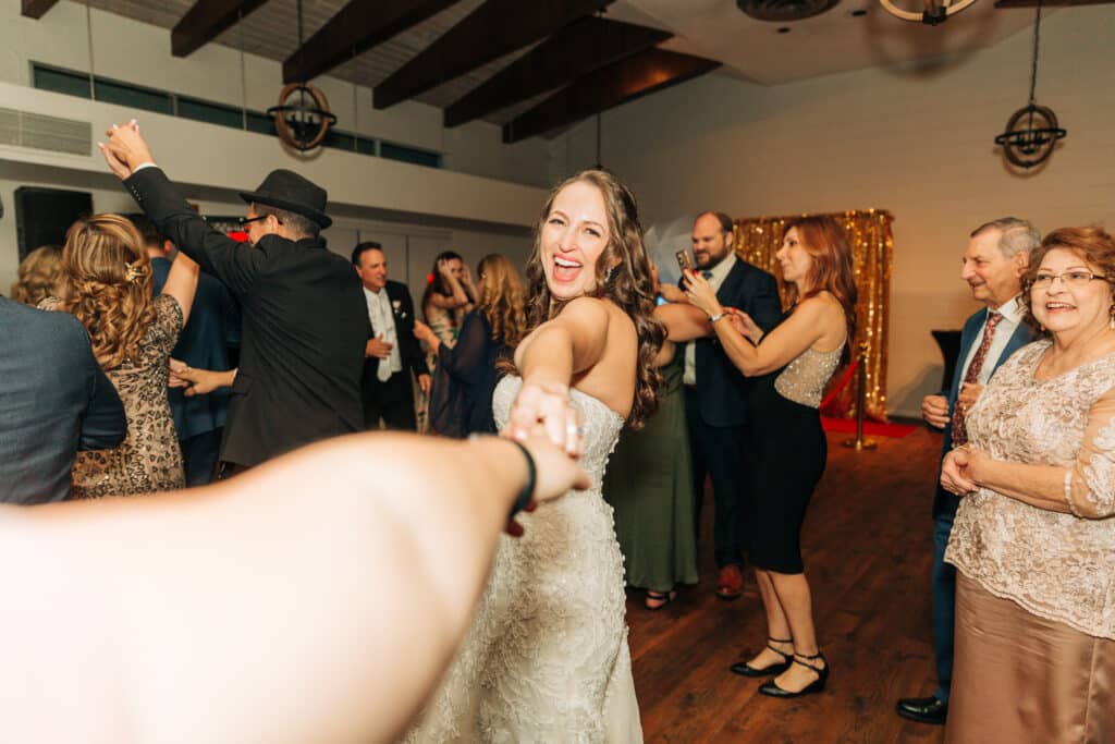bride dancing and smiling at photographer, Sydney Morman Photography