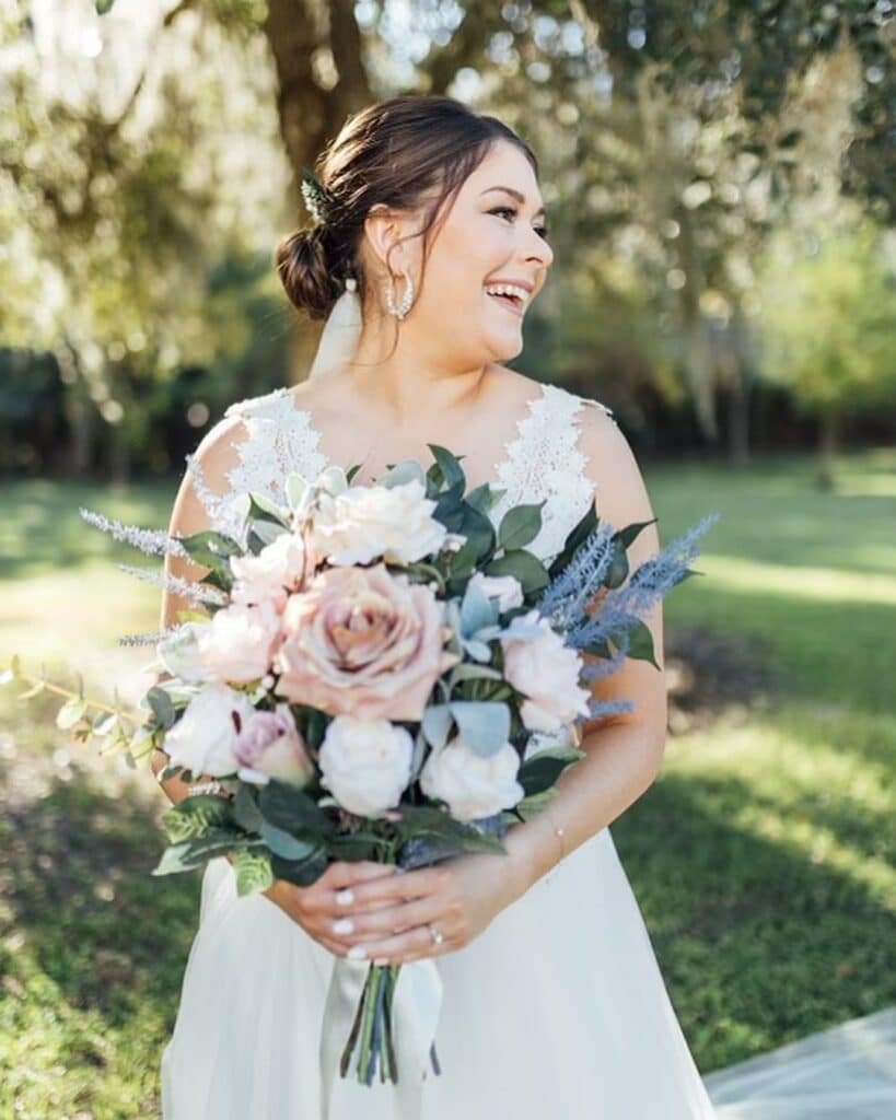 bride with bouquet of silk blush and white roses from Wedding Day Flower Rental