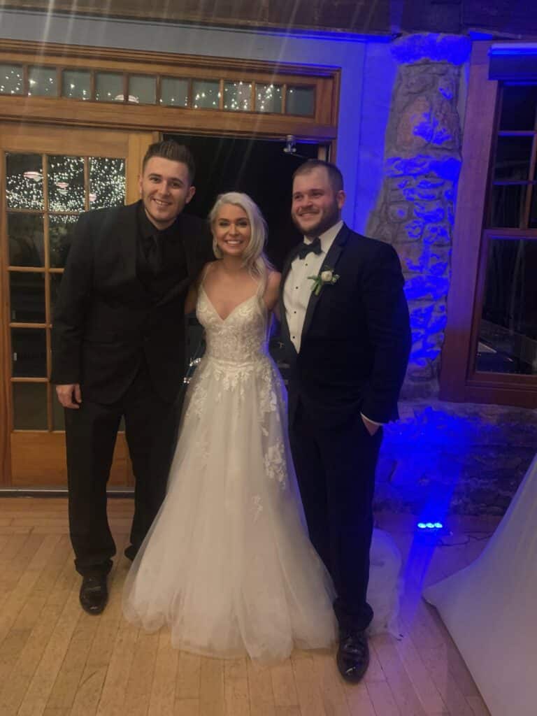 bride and groom standing with DJ from Party Springs Entertainment