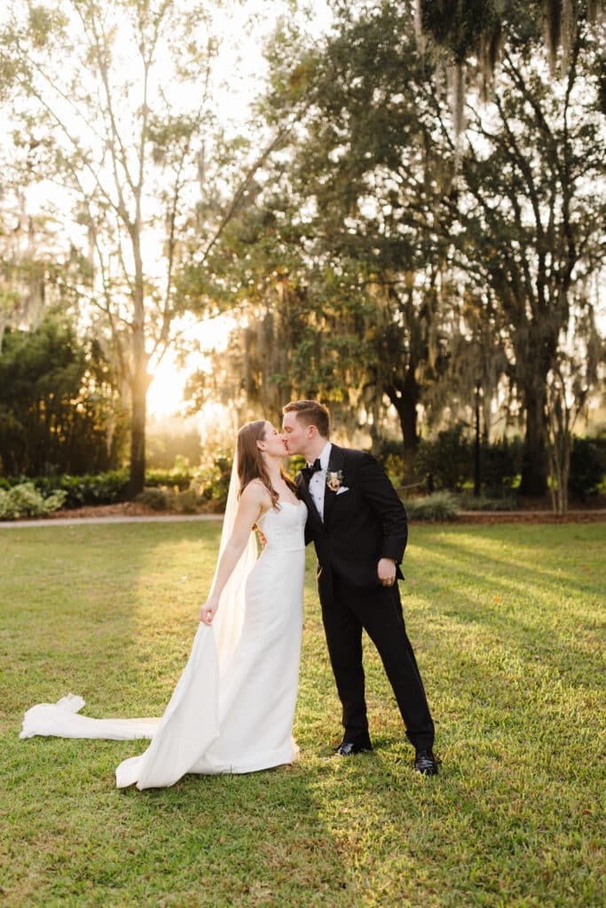 bride and groom kissing outdoors in the golden hour photo by Allie & Joey
