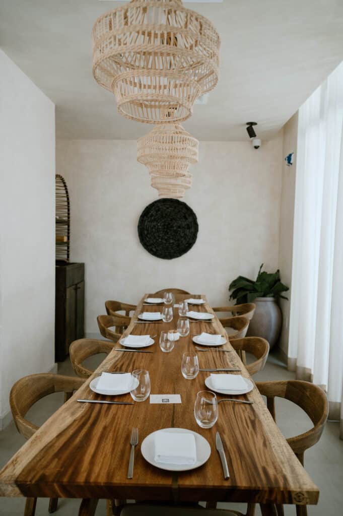 long wooden table under chandelier in private room at AVA MediterrAegean