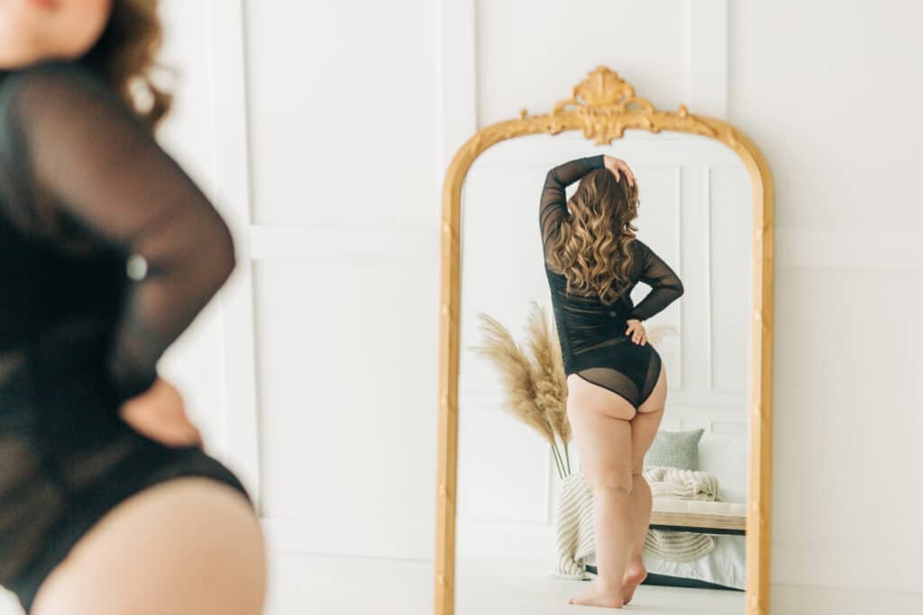 woman in black body suit showing her reflection in a mirror by Sydney Morman Boudoir Photography