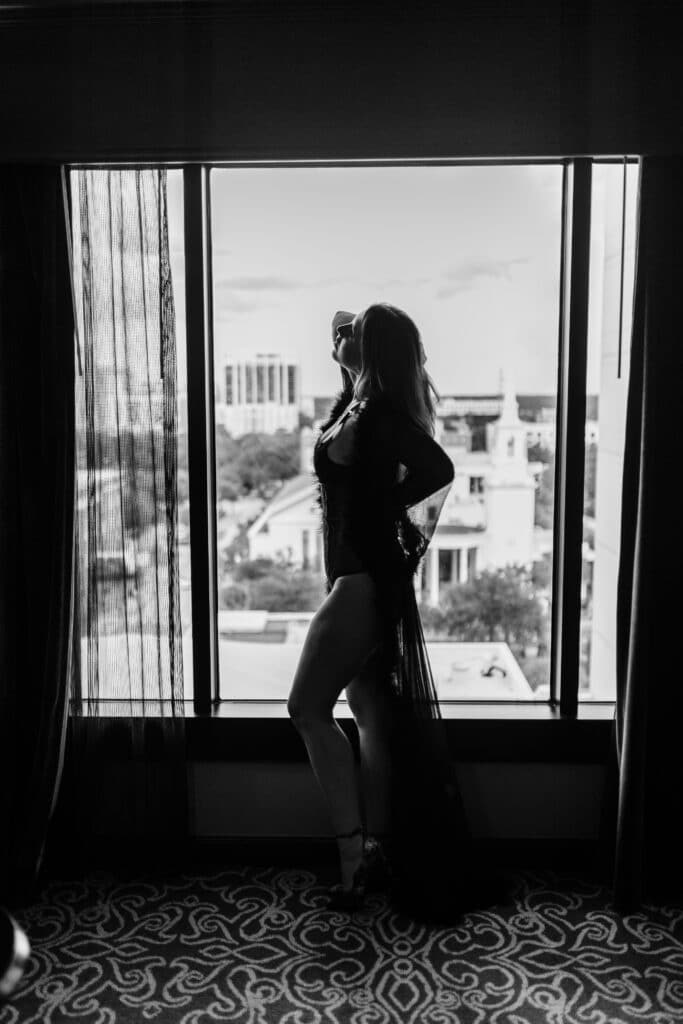 woman in lingerie silhouetted against a glass window by Sydney Morman Boudoir Photography