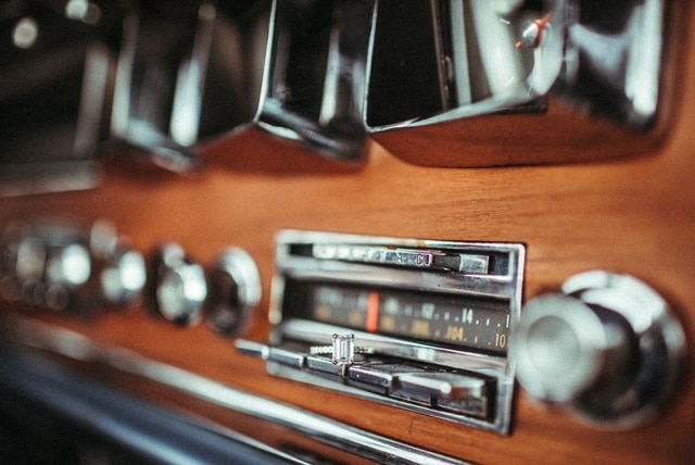 old school car dashboard with old tune radio and wooden dash