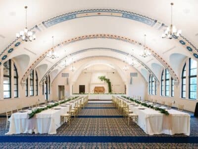 reception hall with 2 long tables leading to the wedding party table