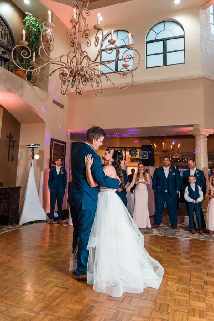 bride and groom dancing first dance with family looking on photo by Jerzy Nieves Photography LLC