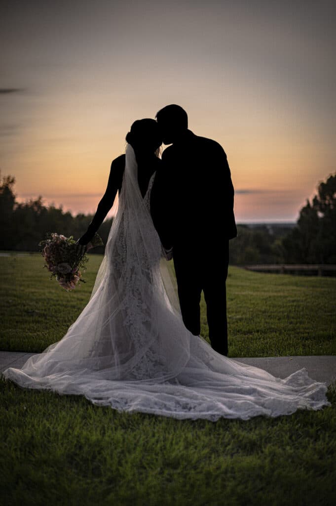 bride and groom silhouetted against sunset at The Carriage House at Vedder Farms