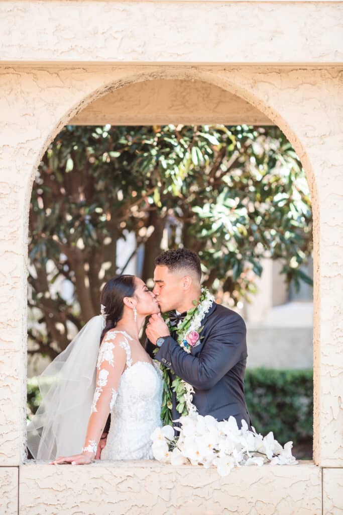 groom kissing bride in alcove photo by Jerzy Nieves Photography LLC