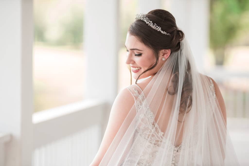 bride with tiara and veil posing for photo by Jerzy Nieves Photography LLC