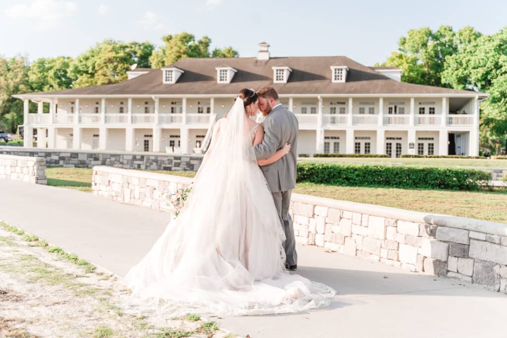 bride and groom having a quiet moment outside of large building on stone walkway photo by Jerzy Nieves Photography LLC