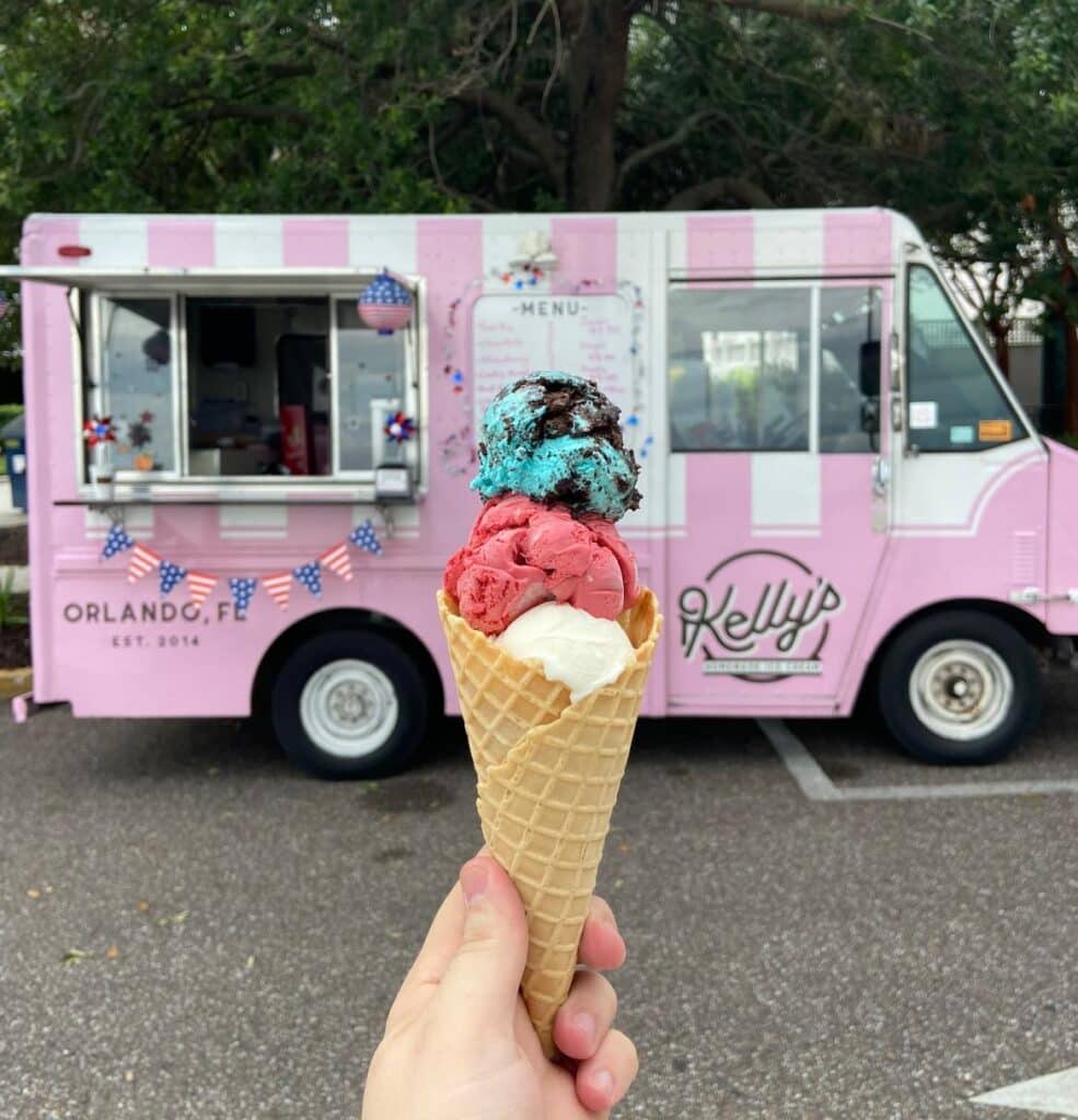 triple flavored ice cream cone in front of Kelly’s Homemade Ice Cream truck