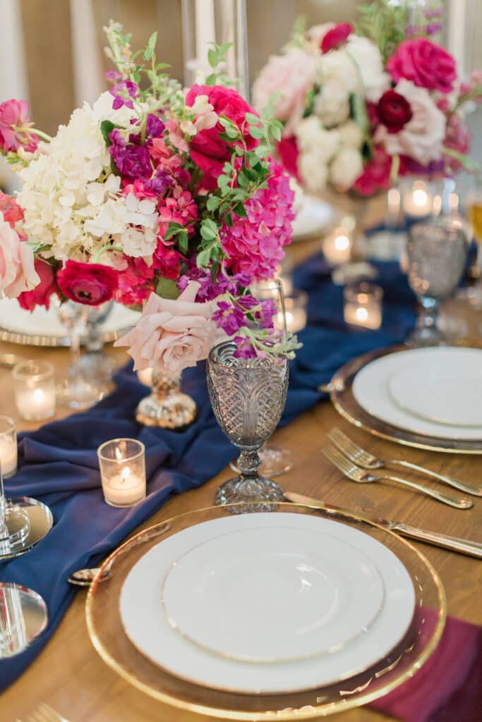 navy table runner on table with gold and pink accents at The Barn at Hidden Oaks Farm of Lake Mary