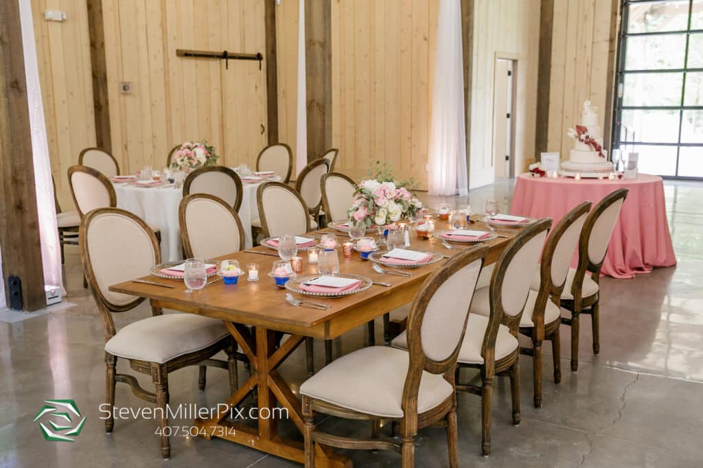 reception room with wooden table and comfortable chairs at The Barn at Hidden Oaks Farm of Lake Mary