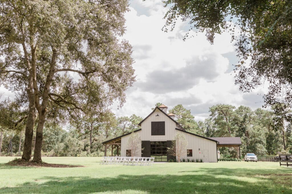 exterior shot of The Barn at Hidden Oaks Farm of Lake Mary in a grass field between the oak trees