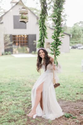 Bride on floral swing at The Barn at Hidden Oaks Farm of Lake Mary