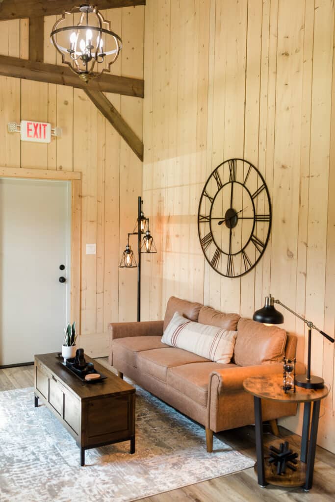 grooms sitting area with wood walls and leather couch at The Barn at Hidden Oaks Farm of Lake Mary