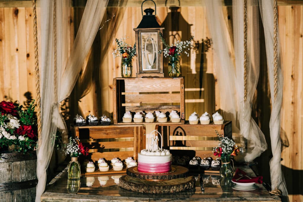 wedding cake area with wooden pallates and lanterns at Bending Branch Ranch in New Smyrna Beach, FL
