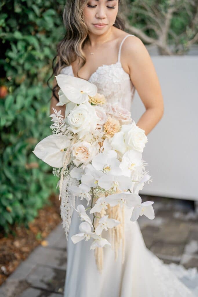 bride with large ruffled bouquet in cream and blush